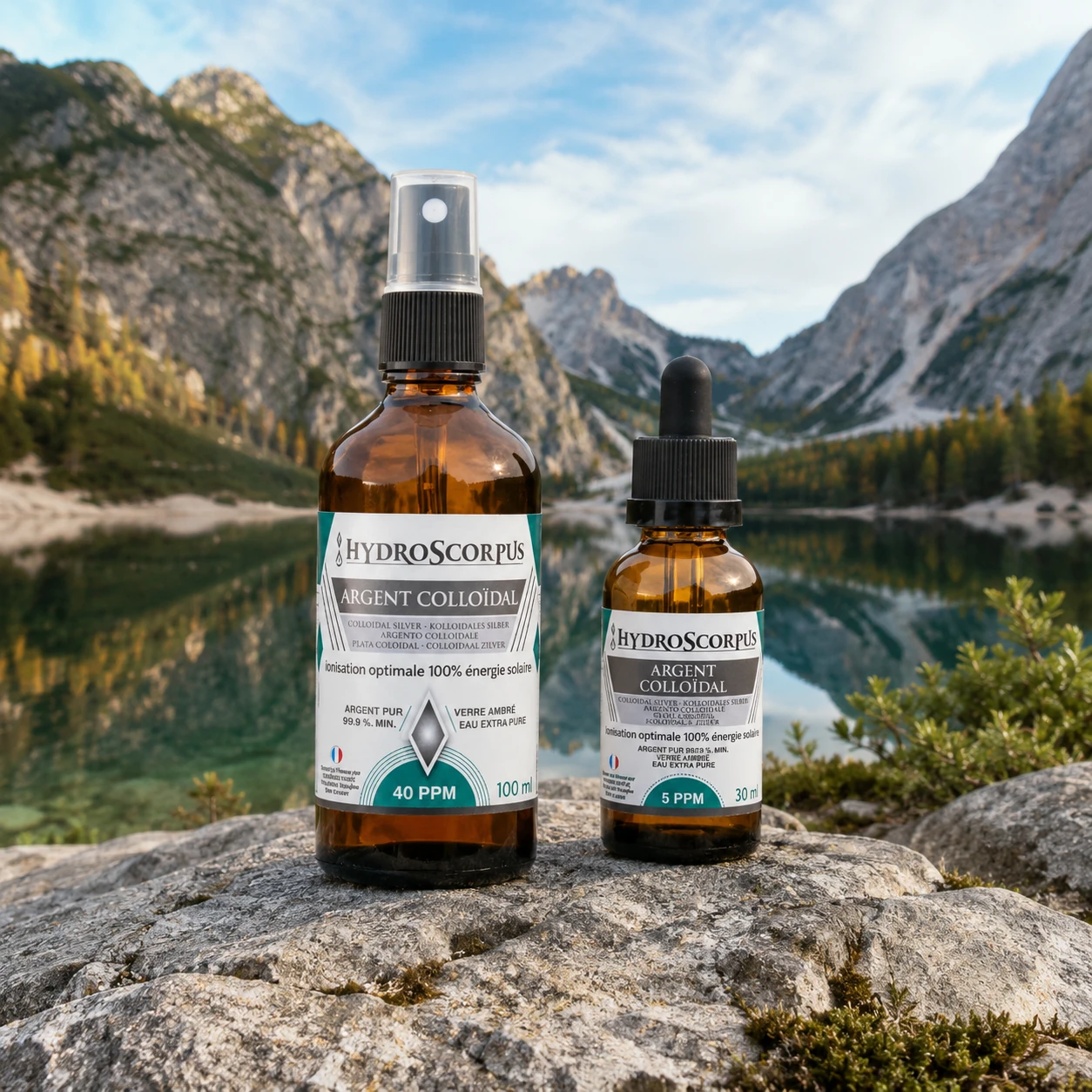 Pack Hydroscorpus spray argent colloïdal 40 PPM 100 ml et compte-gouttes 5 PPM 30 ml devant un lac et des montagnes.